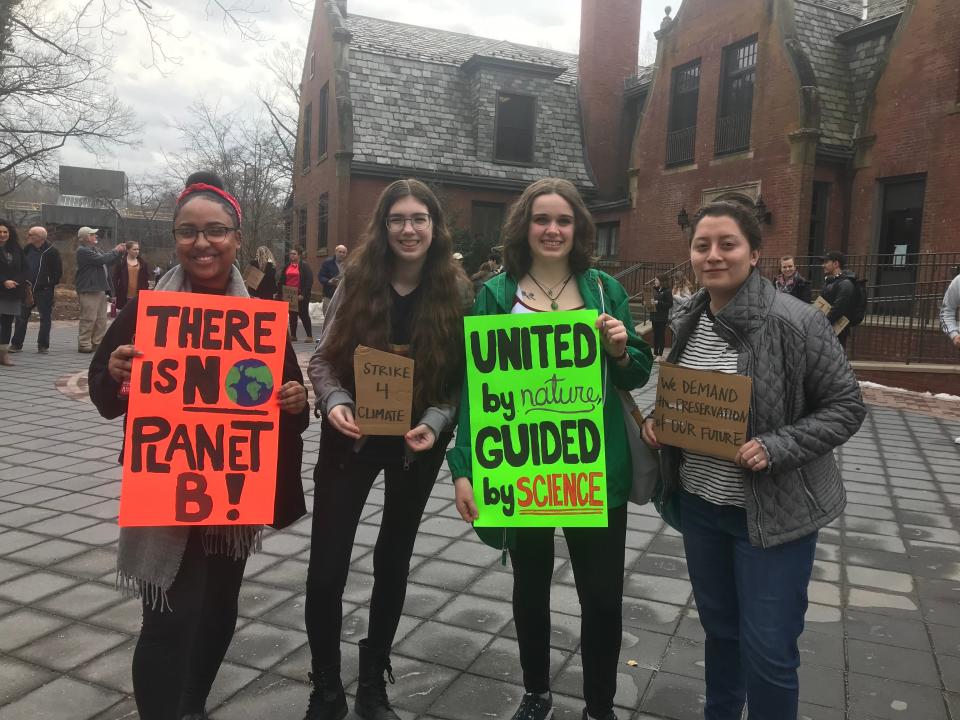 Ramapo College students hold a silent protest for climate change awareness outside of the college's Birch Mansion.