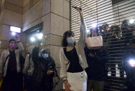 Supporters hold mobile phone lights outside a court in Hong Kong, Thursday, March 4, 2021. A marathon court hearing for 47 pro-democracy activists in Hong Kong charged with conspiracy to commit subversion enters its fourth day on Thursday, as the court deliberates over whether the defendants will be granted bail. (AP Photo/Vincent Yu)