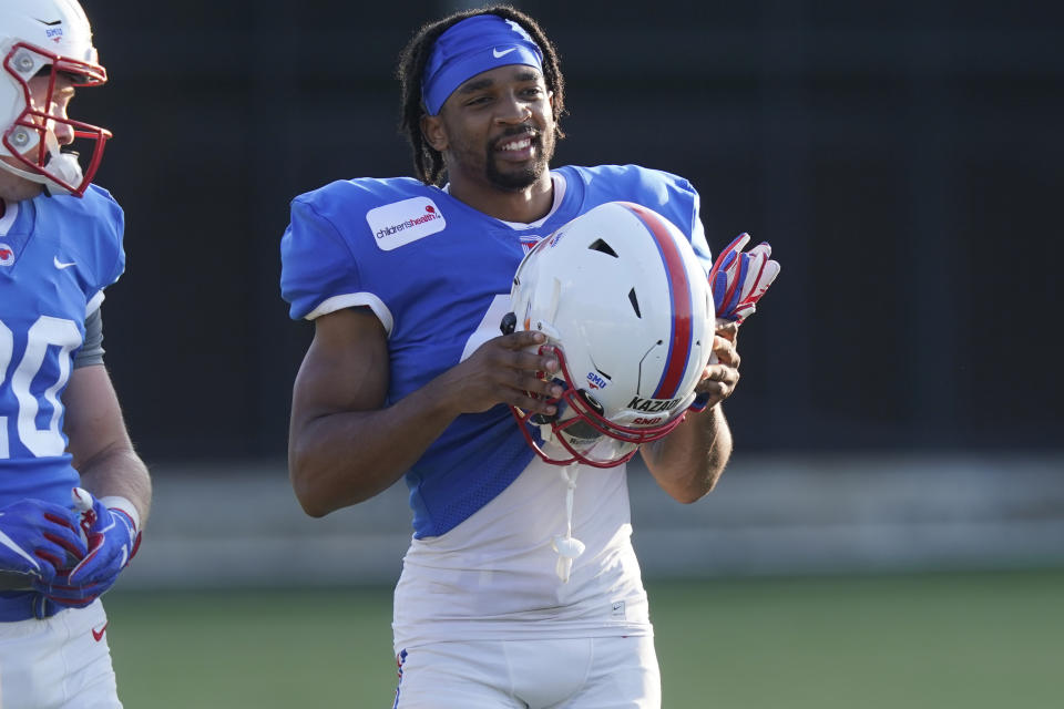 SMU defensive back RaSun Kazadi smiles during an NCAA college football practice Wednesday, Aug. 11, 2021, in Dallas. The end of the NCAA ban on athletes being able to earn money for their fame and celebrity has led to some of them cashing in on their creative side. For Kazadi, it means he can sell his art. (AP Photo/LM Otero)