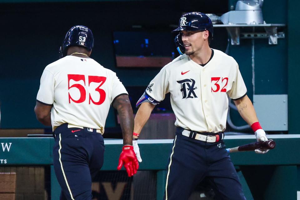 Adolis Garcia and Evan Carter wearing the Rangers' City Connect uniforms in 2023.