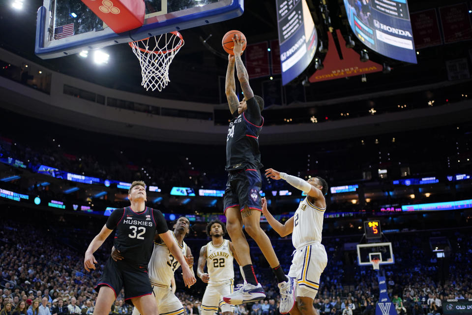 UConn's Jordan Hawkins (24) goes up for a dunk past Villanova's Mark Armstrong (2) during the second half of an NCAA college basketball game, Saturday, March 4, 2023, in Philadelphia. (AP Photo/Matt Slocum)