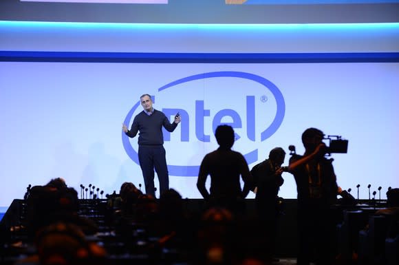 Intel CEO Brian Krzanich on stage with a large Intel logo behind him.