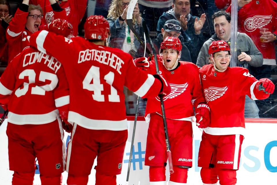 Detroit Red Wings right wing Patrick Kane (88) receives congratulations from teammates after scoring in the second period at Little Caesars Arena in Detroit on Saturday, March 16, 2024.