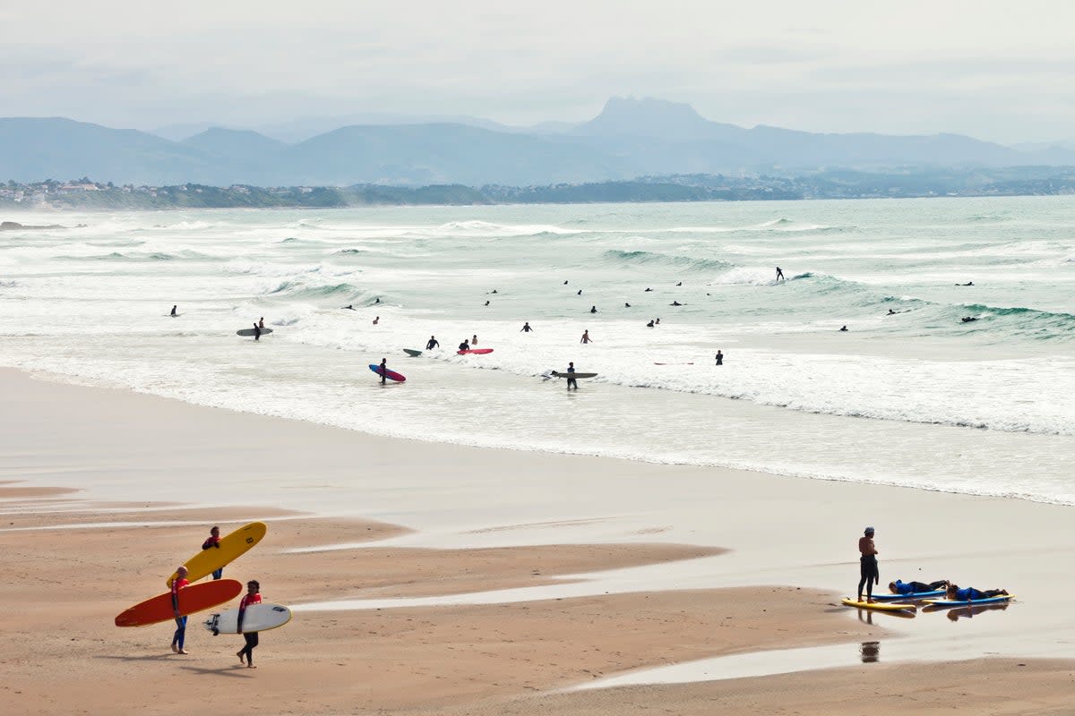 Surfers catch the waves at La Cote des Basques beach in Biarritz (Getty Images)