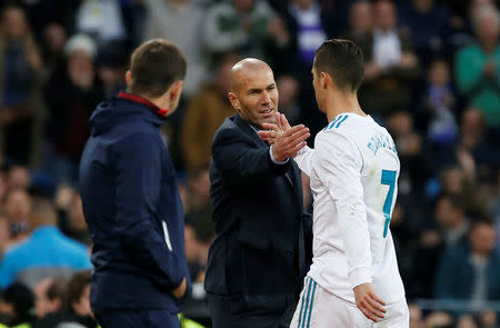 FILE PHOTO: Soccer Football - La Liga Santander - Real Madrid vs Sevilla - Santiago Bernabeu, Madrid, Spain - December 9, 2017 Real Madrid coach Zinedine Zidane shakes hands with Cristiano Ronaldo as he is substituted off REUTERS/Javier Barbancho