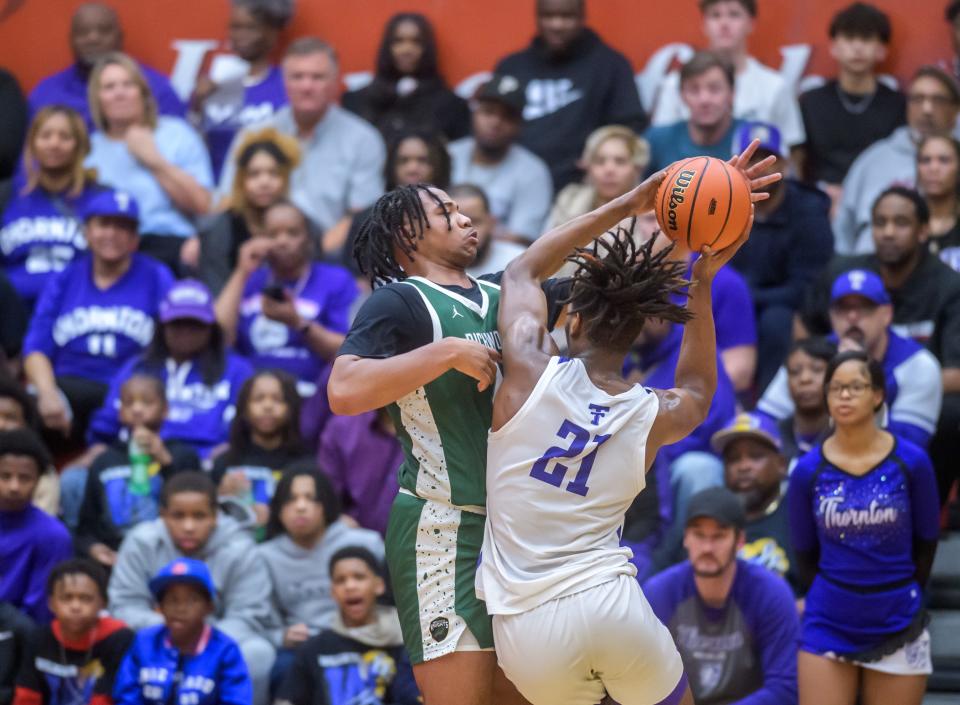 Richwoods' Lathan Sommerville, left, battles Harvey Thornton's Morez Johnson Jr. in the second half of their Class 3A boys basketball supersectional Monday, March 4, 2024 at Ottawa High School. The Knights advanced to the state semifinals with a 58-52 win.