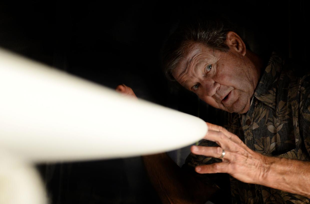 Bill "Blinky" Hubina, 79, owner of Ventura Surf Shop, looks at the shape of one of his boards on Nov. 12. Hubina, who has been shaping boards since the 1960s, was inducted into the International Surfboard Builders Hall of Fame in October.