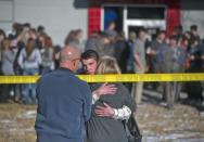 Students gather and reunite with their families at a fast food joint across from Arapahoe High School, after a student opened fire in the school in Centennial, Colorado December 13, 2013. The student seeking to confront one of his teachers opened fire at the Colorado high school on Friday, wounding at least two classmates before apparently taking his own life, law enforcement officials said. REUTERS/Evan Semon (UNITED STATES - Tags: EDUCATION CRIME LAW)