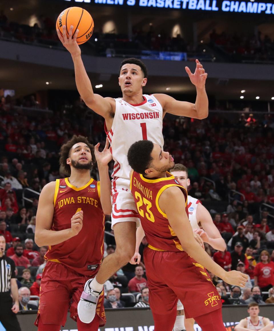 Wisconsin guard Johnny Davis (1) fouls Iowa State guard Tristan Enaruna (23) during the second half in their second round game of the 2022 NCAA Men's Basketball Tournament Sunday, March 20, 2022 at Fiserv Forum in Milwaukee, Wis. Iowa State beat Wisconsin 54-49.