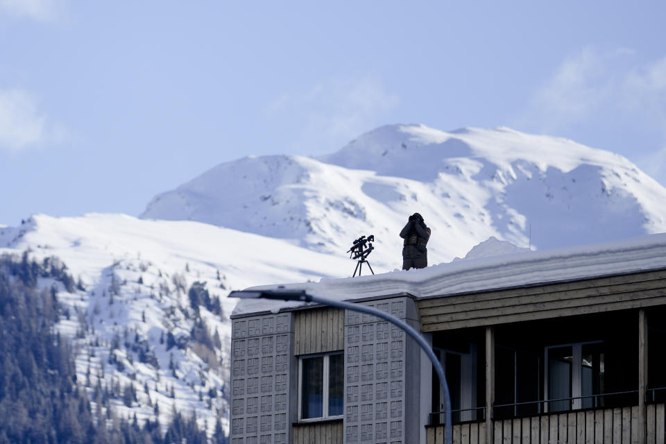 A police officer monitors the area around the Davos Congress Center where the World Economic Forum takes place in Davos, Switzerland, Monday, Jan. 15, 2024. The annual meeting of the World Economic Forum is taking place in Davos from Jan. 15 until Jan. 19, 2024. (AP Photo/Markus Schreiber)