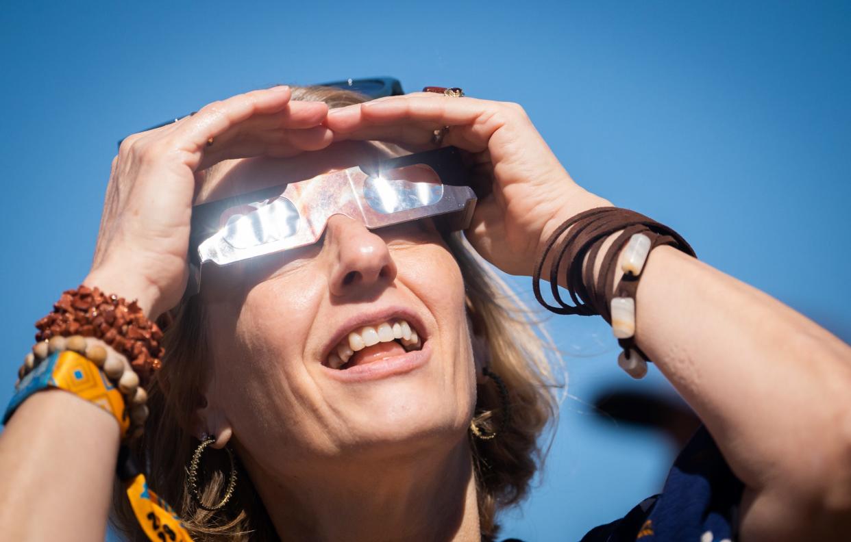 A woman wearing specialized glasses watches last year's annular, or partial, eclipse on the second day of the second weekend of Austin City Limits Music Festival, Saturday, Oct. 14, 2023.