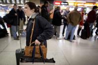 A holiday traveler walks through Penn Station in New York, November 26, 2014. REUTERS/Brendan McDermid