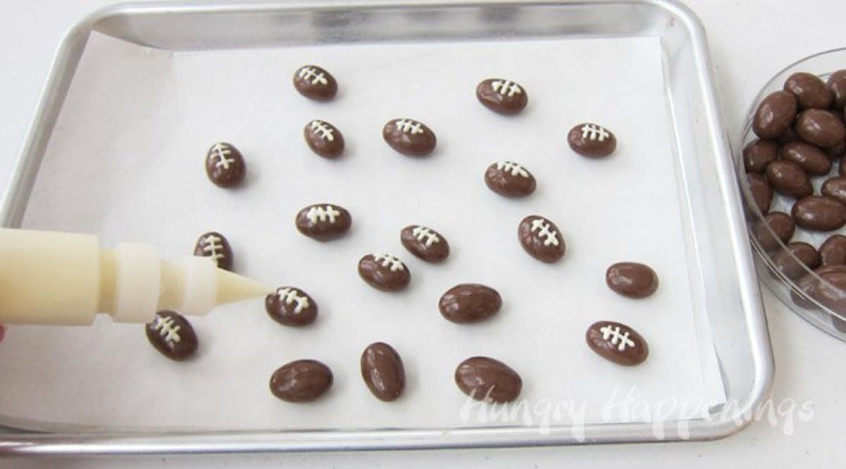 <p>Hungry Happenings</p><p><strong>Get the recipe: </strong><a href="https://hungryhappenings.com/super-bowl-popcorn-with-chocolate-almond-footballs.html/" rel="nofollow noopener" target="_blank" data-ylk="slk:Chocolate Almond Footballs;elm:context_link;itc:0;sec:content-canvas" class="link rapid-noclick-resp"><strong>Chocolate Almond Footballs</strong></a></p>