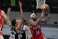 New Orleans Pelicans forward Brandon Ingram (14) scores past San Antonio Spurs forward Keita Bates-Diop (31) during the first half of an NBA basketball game in San Antonio, Saturday, Feb. 27, 2021. (AP Photo/Eric Gay)