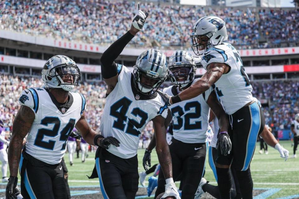 Panthers safety Sam Franklin, Jr., second from left, celebrates in the end zone after a pick six during the game against Minnesota at Bank of America Stadium on Sunday, October 1, 2023 in Charlotte, NC.