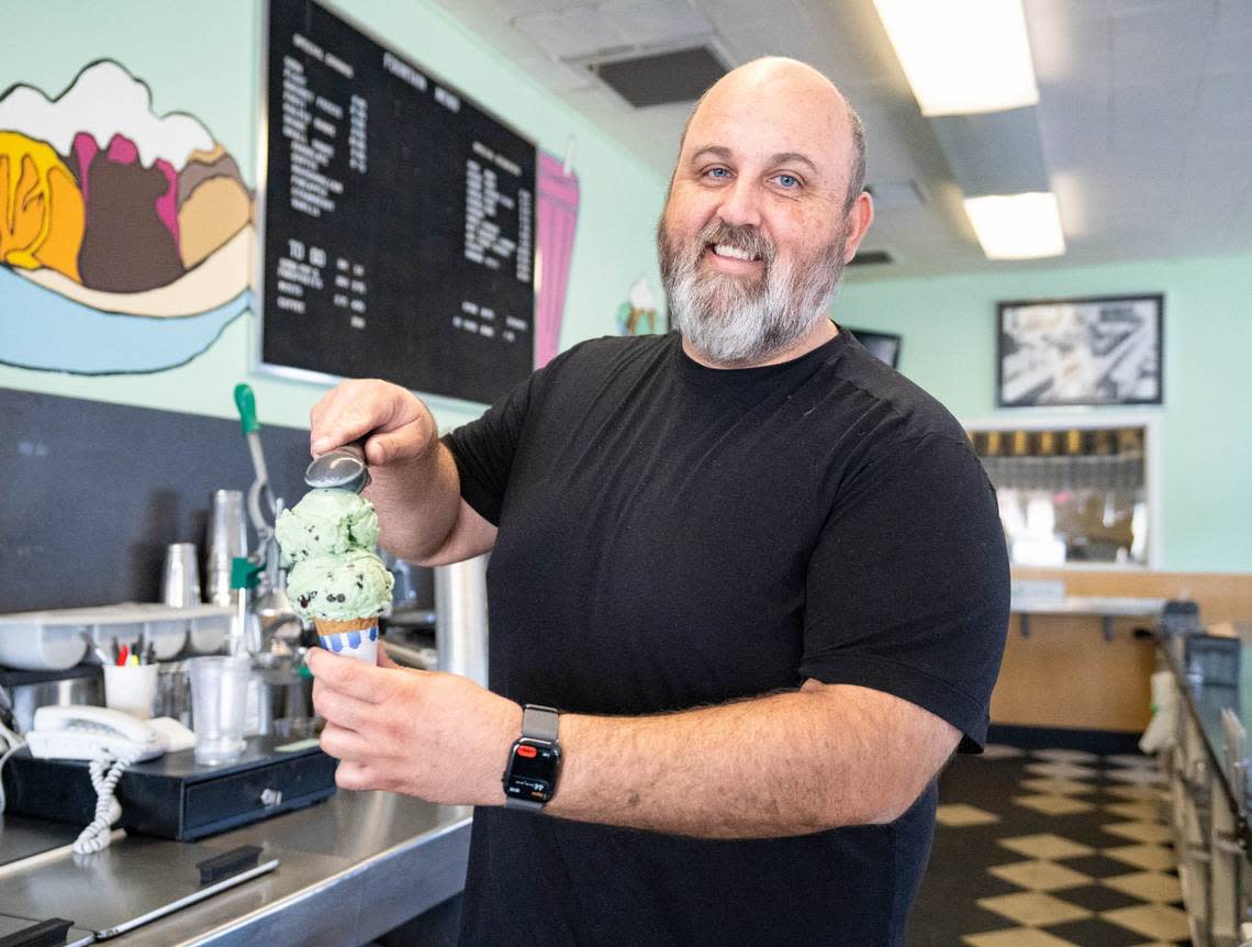 General Manager David Gilson puts two scoops of Mint Chip ice cream on a cone at Vic’s Ice Cream earlier this month. Cameron Clark/cclark@sacbee.com