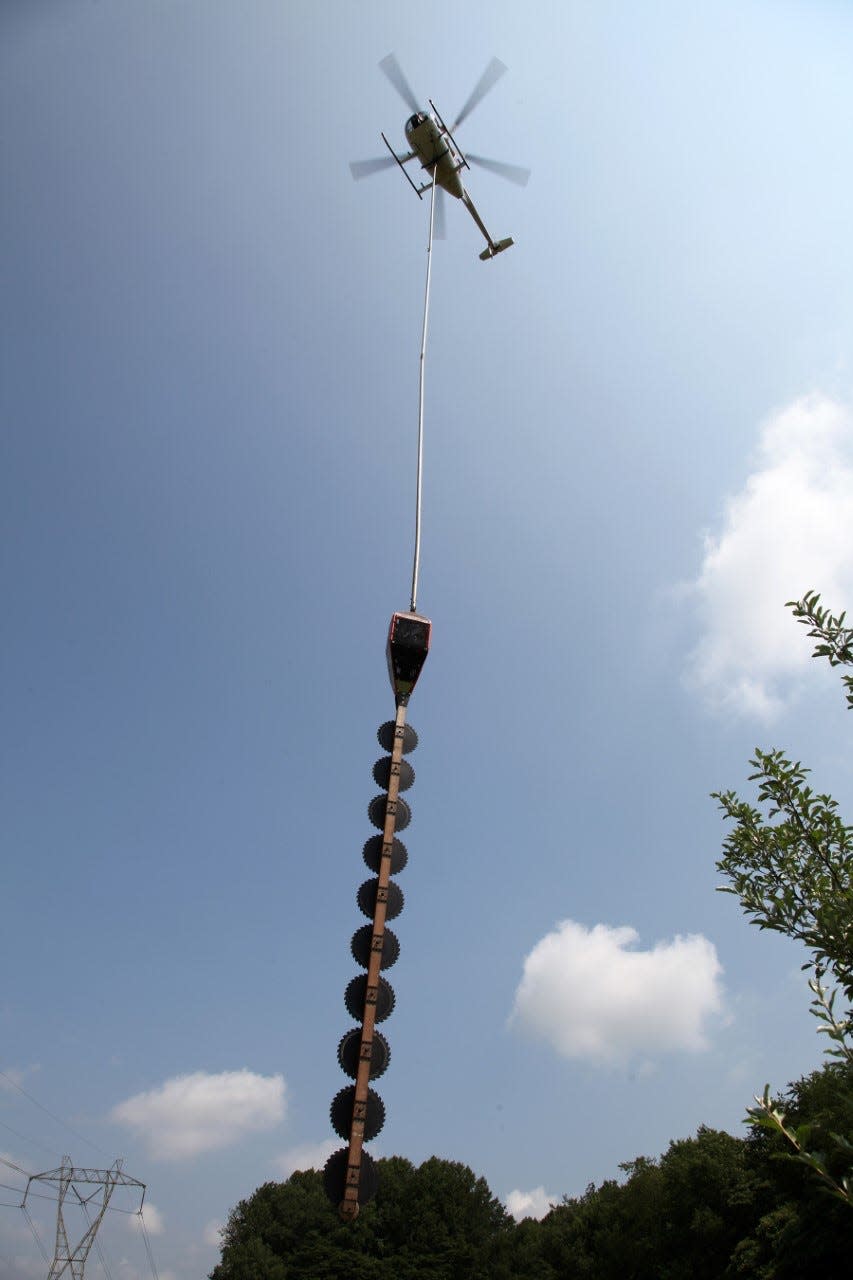 Helicopters equipped with blades to cut back vegetation from power lines are out working in the Akron-Canton region, Ohio Edison says.