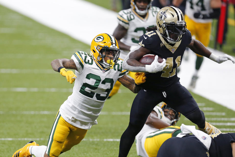 New Orleans Saints running back Alvin Kamara (41) leaps as he carries on a 52 yard touchdown pass play against Green Bay Packers cornerback Jaire Alexander (23) in the second half of an NFL football game in New Orleans, Sunday, Sept. 27, 2020. (AP Photo/Brett Duke)