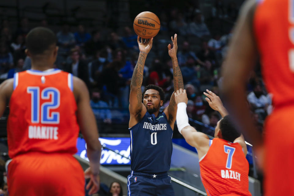 Dallas Mavericks forward Sterling Brown (0) attempts to shoot as Oklahoma City Thunder forward Darius Bazley (7) defends during the first half of an NBA basketball game, Monday, Jan. 17, 2022, in Dallas. (AP Photo/Brandon Wade)