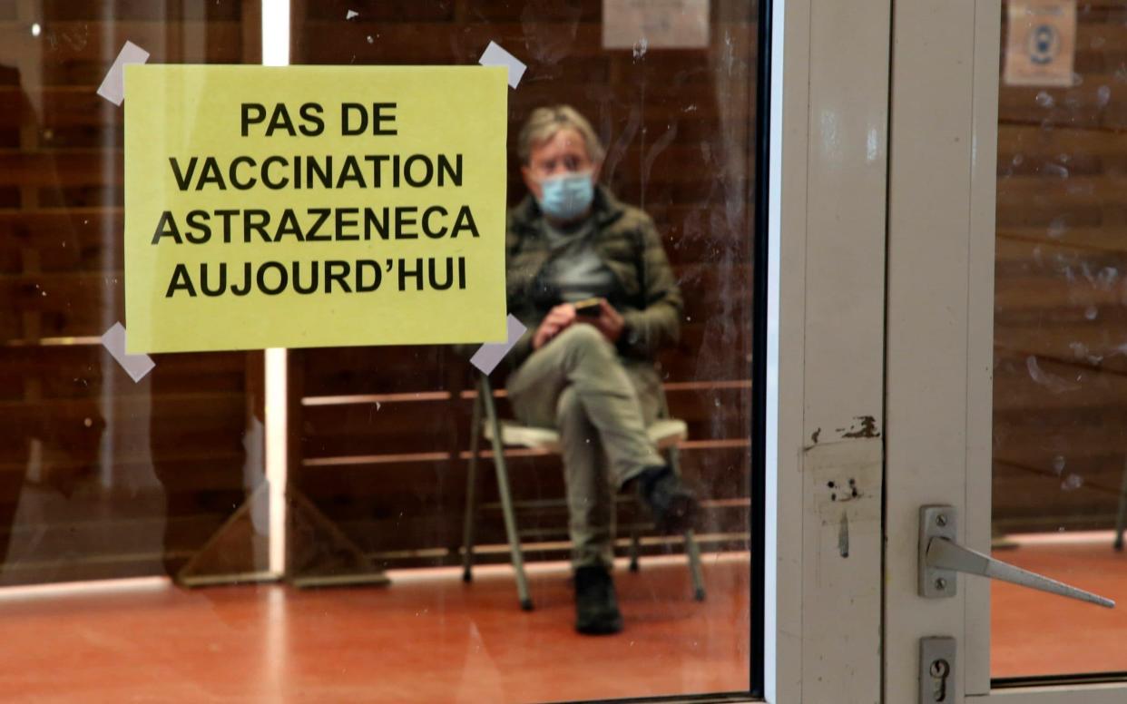 A man waits at a vaccination centre in Saint-Jean-de-Luz, south-western France, where a sign reads: 'No AstraZeneca vaccinations today' - Bob Edme/ AP