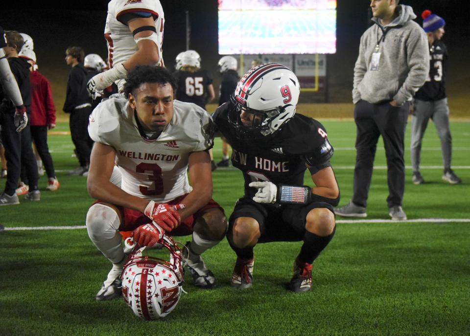 New Home's Nevin Mojica, right, comforts Wellington's Jordan Nation after New Home's Region I-2A Division I championship win against Wellington, Friday, Dec. 2, 2022, at Happy State Bank Stadium in Canyon.