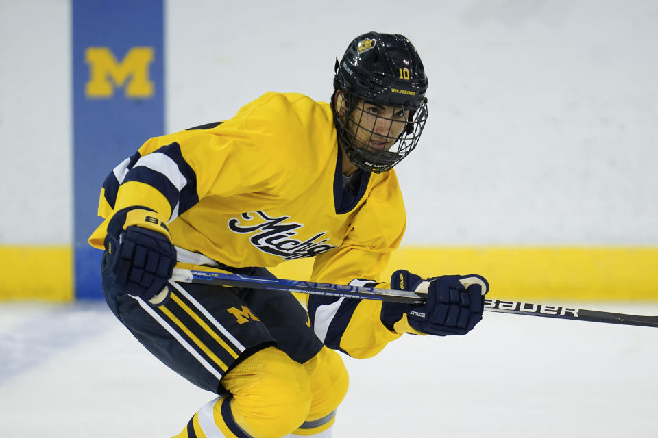 FILE - University of Michigan center Matty Beniers (10) skates during an NCAA college hockey practice in Ann Arbor, Mich., Sept. 22, 2021. USA Hockey on Thursday, Jan. 13, 2022, unveiled its 25-man roster with 15 players from college, headlined by 2021 No. 2 pick Beniers of the Seattle Kraken and 2020 No. 5 pick Jake Sanderson of the Ottawa Senators. Brendan Brisson, a Michigan teammate of Beniers and a first-round pick of the Vegas Golden Knights, was also named to the team. (AP Photo/Paul Sancya, File)