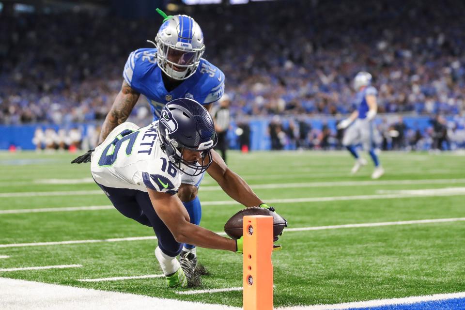 Seattle Seahawks wide receiver Tyler Lockett (16) stetches out toward the pylon for the game-winning touchdown after making a catch against Detroit Lions safety Brian Branch in overtime.