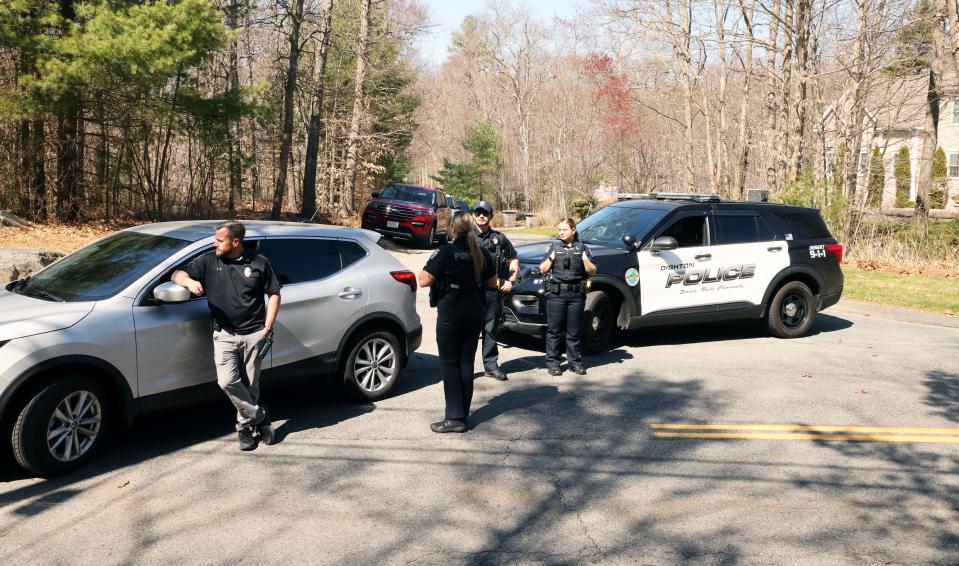 Agents swarm a Dighton, Massachusetts, home on Thursday.