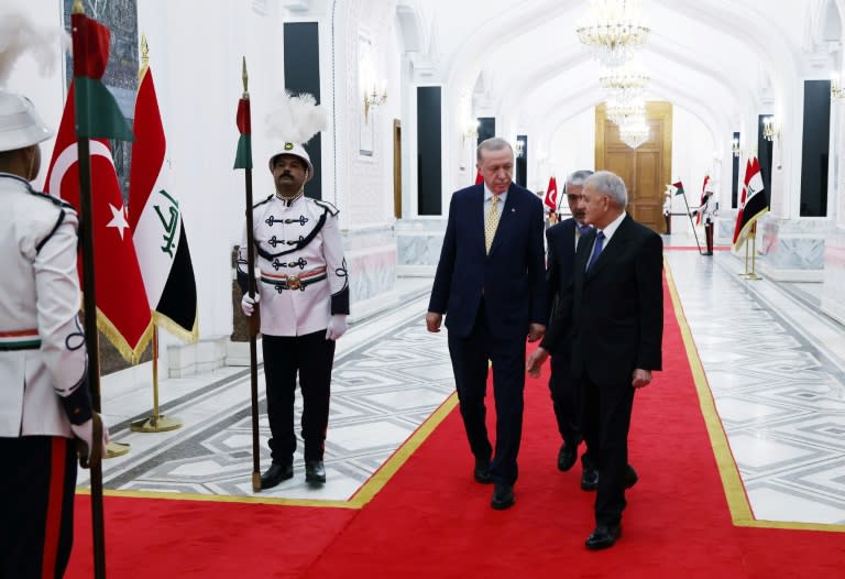 A photograph provided by the Turkish presidency press office shows Iraq's President Abdul Latif Rashid (R) welcoming Turkey's President Recep Tayyip Erdogan prior to their meeting at the Presidential palace in Baghdad (Handout)