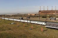 A COVID-19 vaccination train is parked at the Swartkops railroad yard outside Gqeberha, South Africa, Thursday Sept. 23, 2021. South Africa has sent a train carrying COVID-19 vaccines into one of its poorest provinces to get doses to areas where healthcare facilities are stretched. The vaccine train, named Transvaco, will go on a three-month tour through the Eastern Cape province and stop at seven stations for two weeks at a time to vaccinate people. (AP Photo/Jerome Delay)