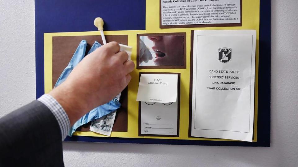 Idaho State Police Forensic Services Director Matthew Gamette holds up a sample swab to demonstrate how DNA samples are collected from people convicted of a felony in Idaho. Over 66,000 DNA samples from those convicted of some kinds felony crimes are housed at the forensic facility in Meridian.