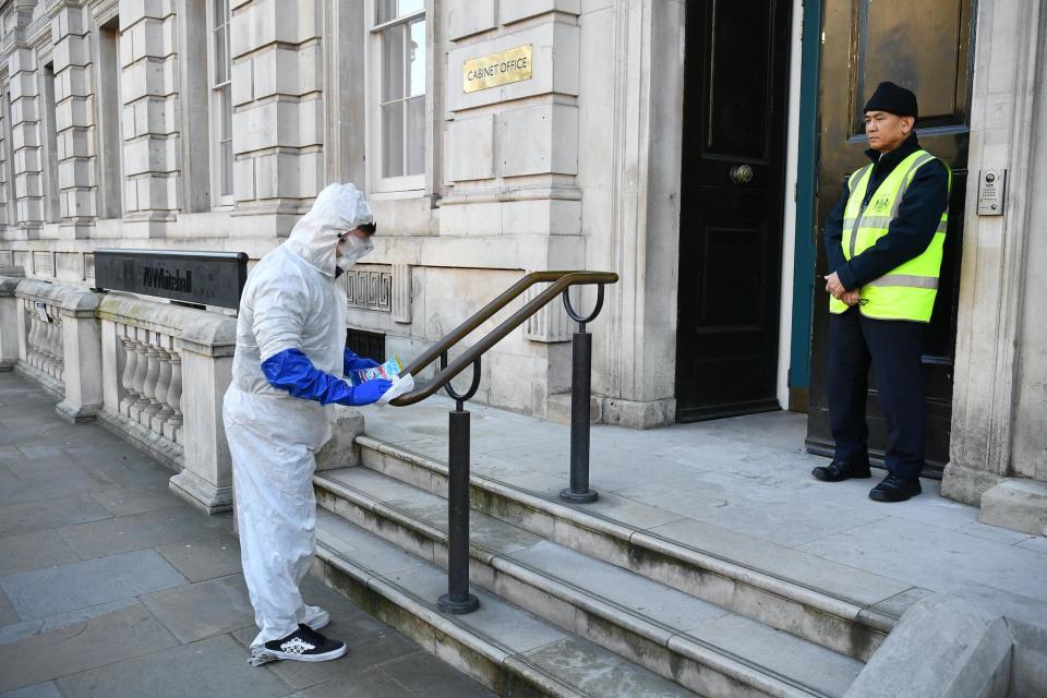 kids create a tiktok video in fake hazmat suits outside the Cabinet Office after a COBRA meeting: Leon Neal/Getty Images