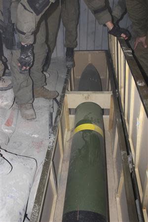 Israeli soldiers stand next to a rocket on a ship they seized in the Red Sea in this handout picture released by the Israel Defence Forces (IDF) March 5, 2014. REUTERS/IDF/Handout