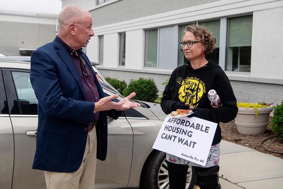 Jen Hampton, right, chair of Asheville Food and Beverage United, talks with Michael Kryzanek, Vice President of business development at the Buncombe County TDA May 31, 2023.