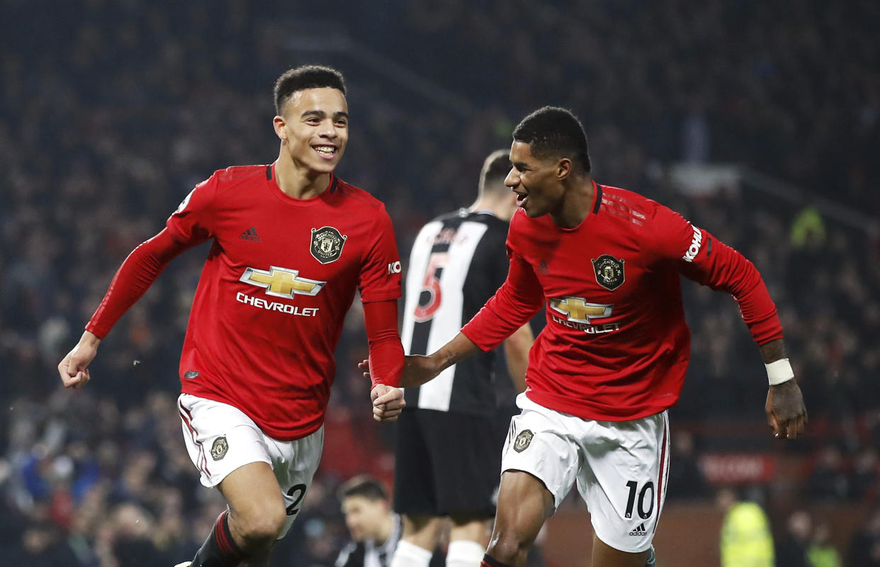 Manchester United's Mason Greenwood celebrates scoring his side's second goal of the game with teammate Marcus Rashford during their English Premier League soccer match against Newcastle United at Old Trafford, Manchester, England, Thursday, Dec. 26, 2019. (Martin Rickett/PA via AP)