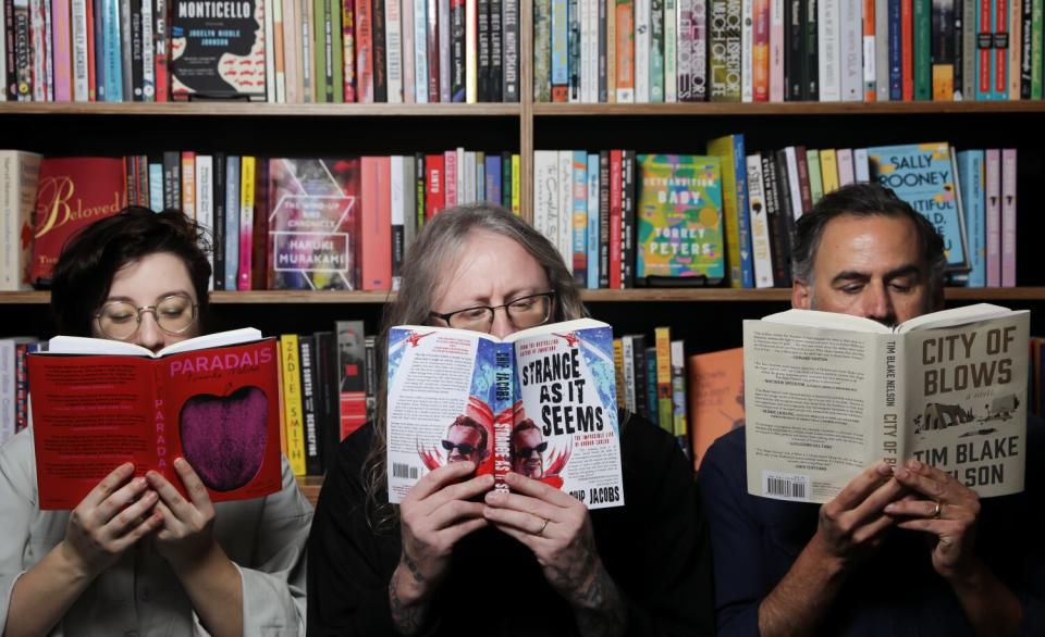 From left, store manager Madeline Gobbo, Rare Bird founder Tyson Cornell hold up books at North Figueroa Bookshop.