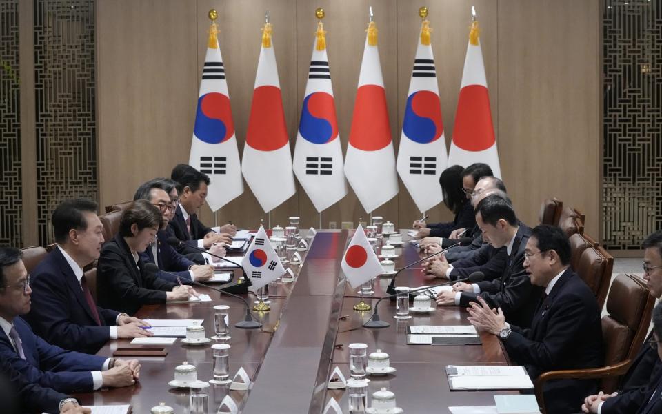 Japanese primemMinister Fumio Kishida (2-R) speaks to South Korean president Yoon Suk Yeol (2-L) during a meeting in Seoul on Sunday