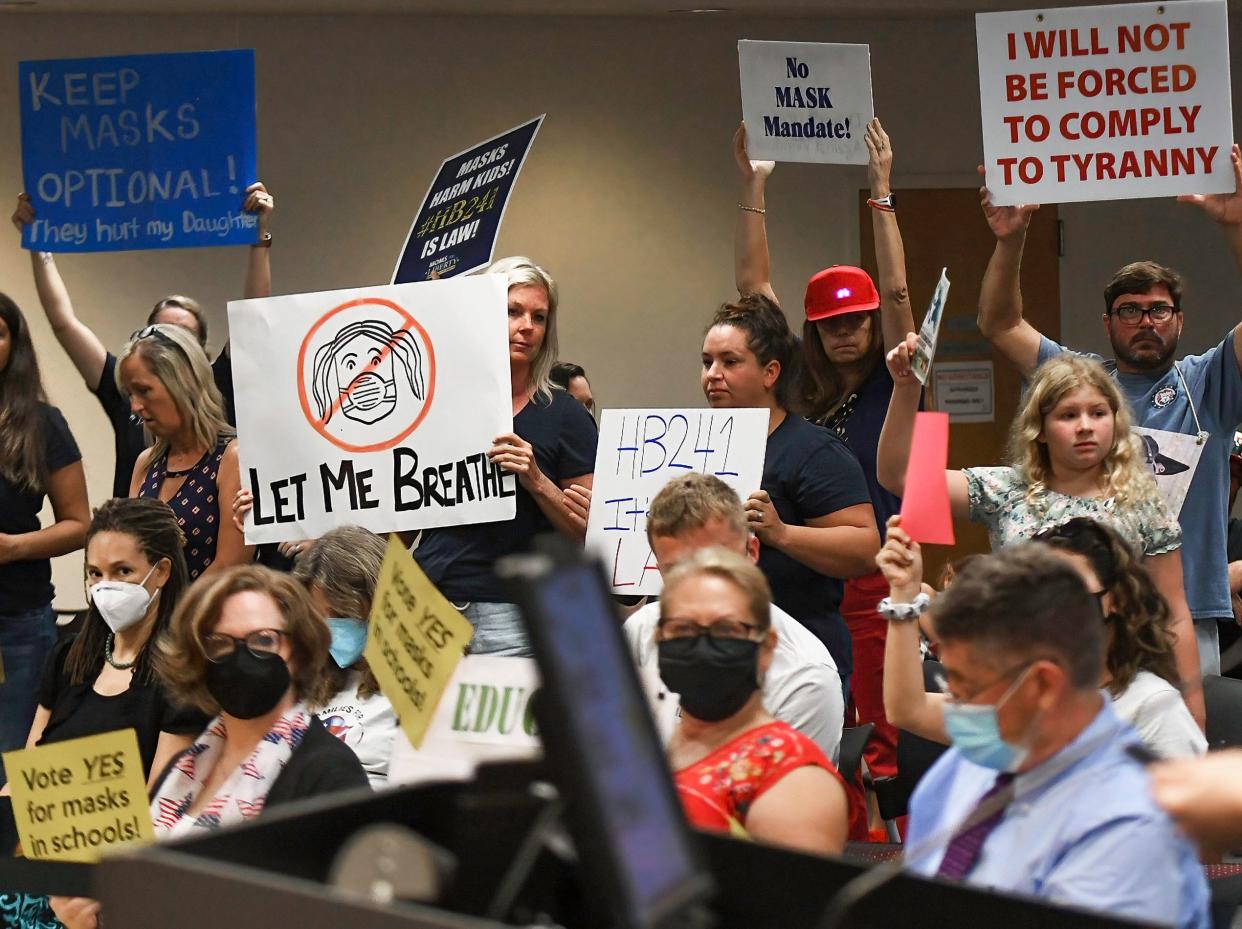 People demonstrate at an emergency meeting of the Brevard County, Florida School Board in Viera to discuss whether face masks in local schools should be mandatory.
