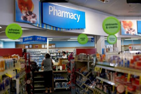 FILE PHOTO -  A customer waits at the counter of a CVS Pharmacy store in Pasadena, U.S., May 2, 2016. REUTERS/Mario Anzuoni/File Photo