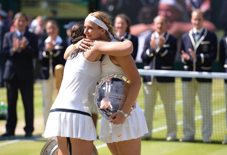 France's Marion Bartoli (left) hugs Germany's Sabine Lisicki after winning the Ladies' Singles Final during day twelve of the Wimbledon Championships at The All England Lawn Tennis and Croquet Club, Wimbledon.