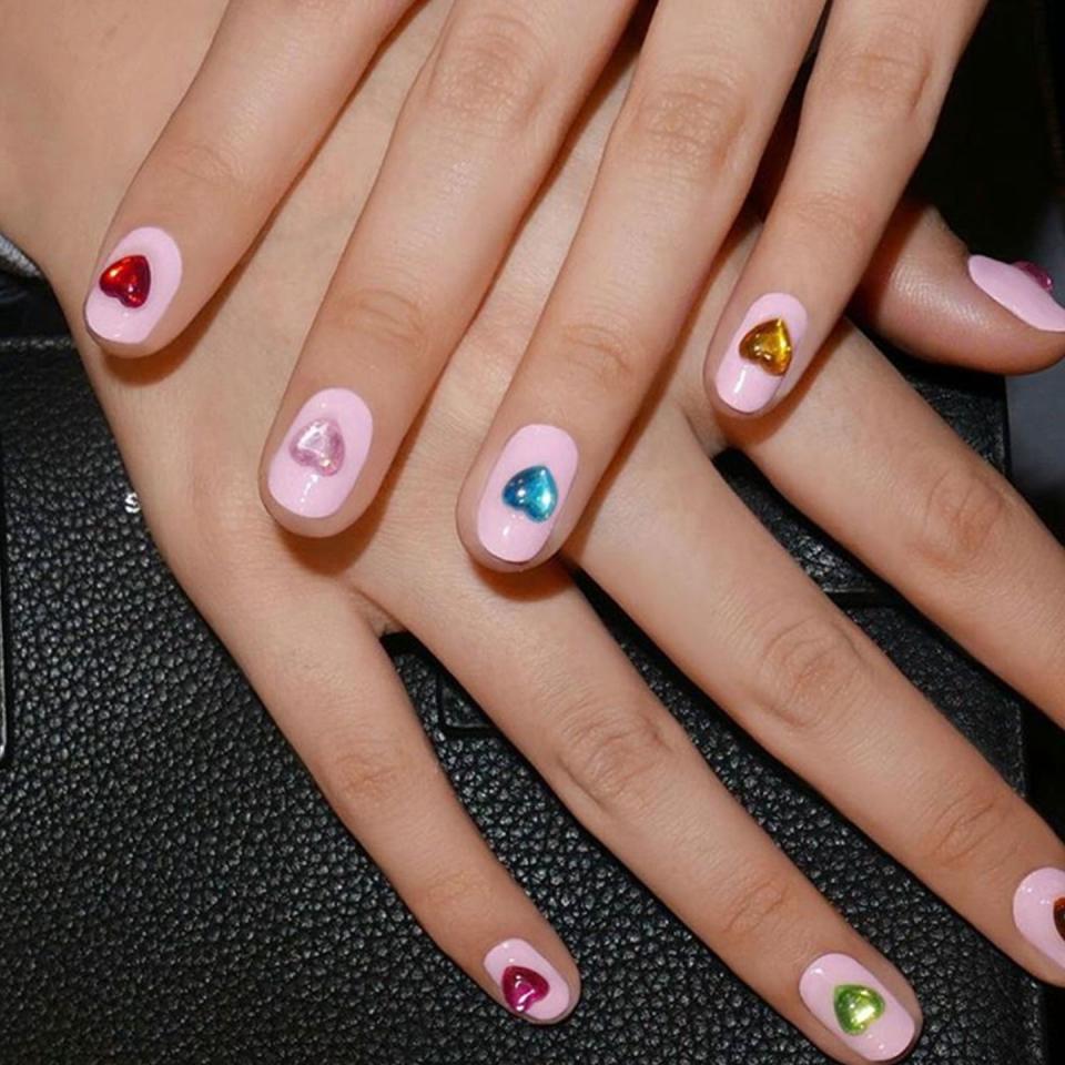 <p>Add extra oomph to your nails with a gem or jewel. Paint the base coat millennial pink and top with heart appliqués in the center for an easy but playful design.</p><p><em>Design by <a href="https://www.instagram.com/p/Bd5qLbthFxA/?taken-by=aliciatnails" rel="nofollow noopener" target="_blank" data-ylk="slk:@aliciatnails;elm:context_link;itc:0;sec:content-canvas" class="link ">@aliciatnails</a></em></p>