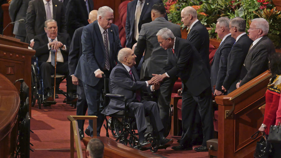 President Russell M. Nelson, center, greets Gerrit Walter Gong, a member of the Quorum of the Twelve Apostles of the Church of Jesus Christ of Latter-day Saints, following The Church of Jesus Christ of Latter-day Saints twice-annual conference, Saturday, April 6, 2024, in Salt Lake City. (AP Photo/Rick Bowmer)