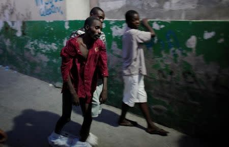 A Haitian with cholera arrives to receive treatment at St-Catherine hospital in the slum of Cite-Soleil in Port-au-Prince November 19, 2010. REUTERS/Eduardo Munoz/File Photo