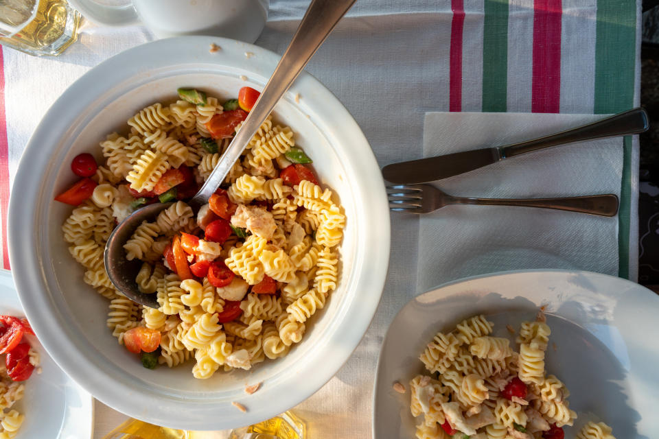 Bowls of pasta with tomatoes.