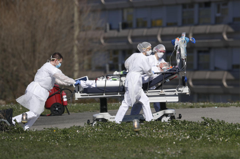 FILE - In this March 23, 2020 file photo, a victim of the COVID-19 virus is evacuated from the Mulhouse civil hospital, eastern France. The picture is still grim in parts of Europe and Asia as variants of the virus fuel an increase in new cases and the worldwide death toll closes in on 3 million. (AP Photo/Jean-Francois Badias, File)