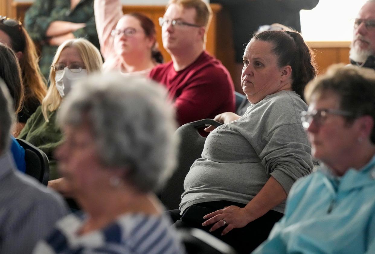 Melissa Boyer of East Palestine, right, listens to attorneys during a meeting with East Palestine residents at the American Legion in East Palestine Wednesday, February 15, 2023, to discuss their legal options in the wake of the Feb. 3 train derailment and ensuing burn of chemicals held in several tanker cars. Boyer lives less than a mile from the derailment.