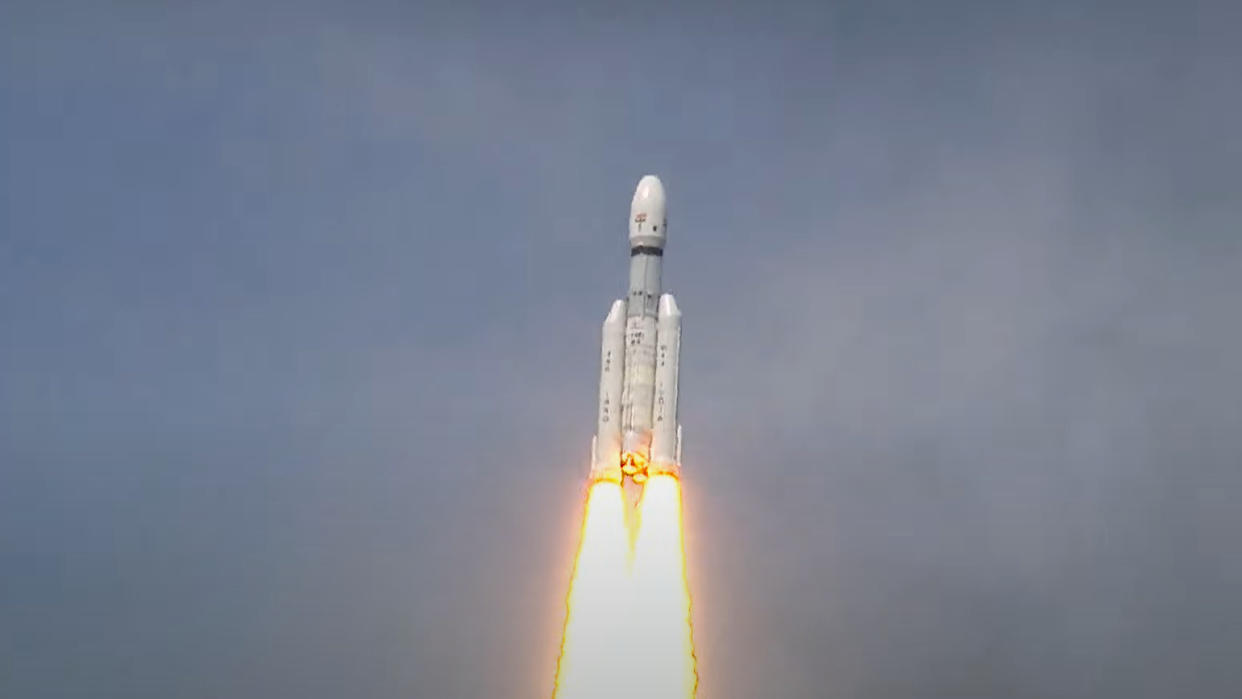  a white lvm3 rocket climbs into a blue sky 