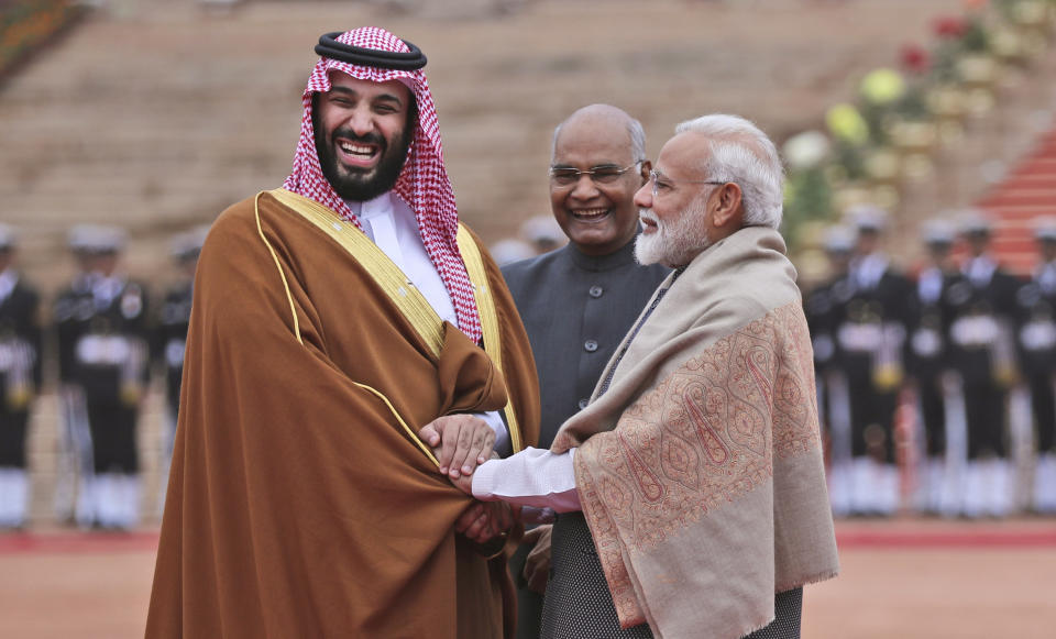 FILE - In this Feb. 20, 2019 file photo, Saudi Arabia's Crown Prince Mohammed bin Salman shakes hand with Indian Prime Minister Narendra Modi during a ceremonial welcome in New Delhi, India. Amid the Kashmir crisis, Gulf Arab states balance relations with Muslim-majority Pakistan and trade partner India. Saudi Arabia’s response to the Kashmir situation is complicated by its close ties with both India and Pakistan, which have fought two wars over the disputed Himalayan region, as well as its ideological rivalry with Turkey and Iran for supremacy in the Islamic world. (AP Photo/Manish Swarup, File)