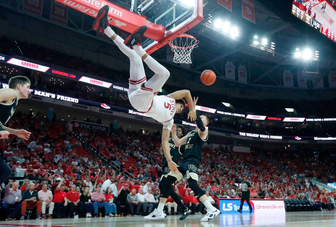 N.C. State’s Jack Clark (5) takes a hard fall after dunking the ball during N.C. State’s 90-74 victory over Wake Forest at PNC Arena in Raleigh, N.C., Wednesday, Feb. 22, 2023.