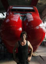 Czech artist David Cerny poses next to a London bus that he has transformed into a robotic sculpture in Prague July 2, 2012. The bus, which Cerny hopes could become an unofficial mascot of the London 2012 Olympic Games, does push-ups with the help of an engine powering a pair of robotic arms, and the motion is accompanied by a recording of sounds evoking tough physical effort. It will be parked outside the Czech Olympic headquarters in London for the duration of the Games. (REUTERS/Petr Josek)